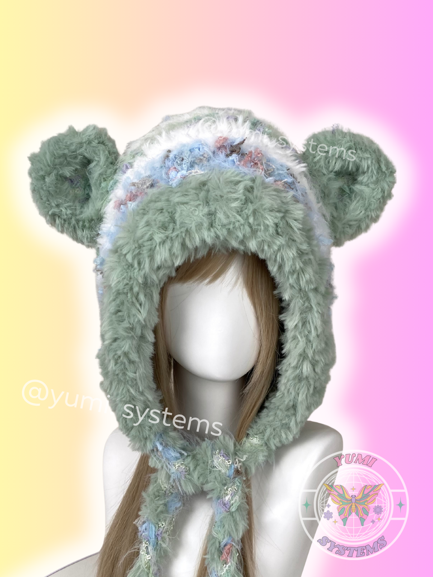 YUMI SYSTEMS Sage Green and Lavender Shaggy Crochet Bonnet with Detachable Ears on Mannequin.