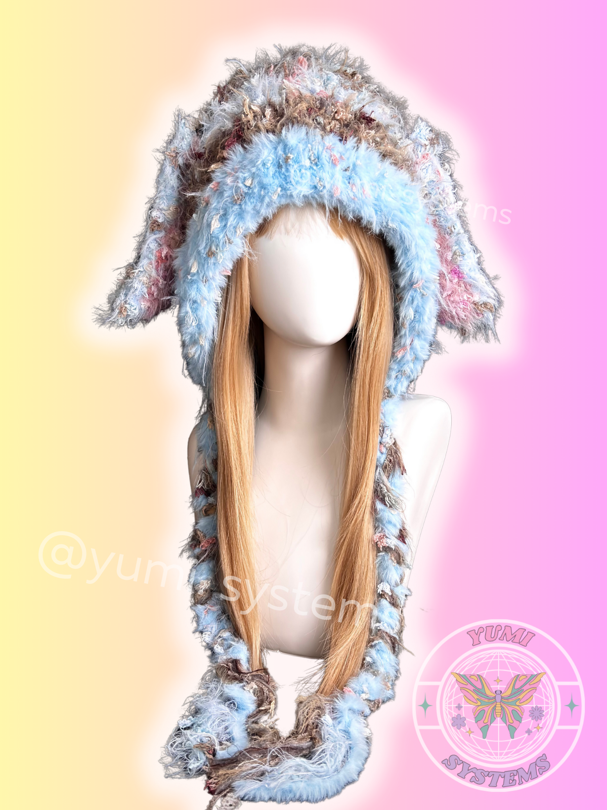  Close-up of a thick, colorful handmade animal ear hat with long tassels on a mannequin.