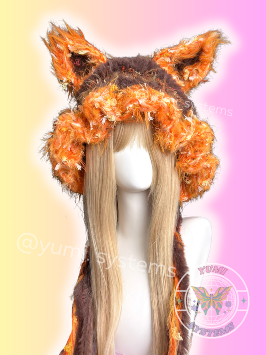 Close-up of a thick, colorful handmade animal ear hat with long tassels on a mannequin.