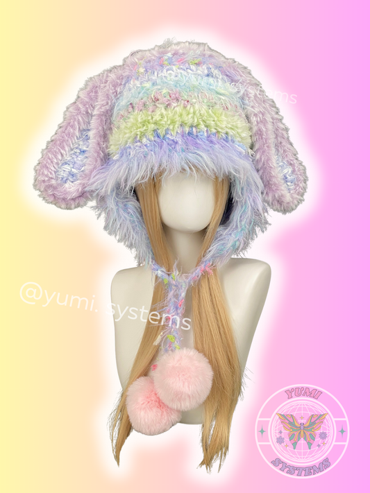 Three variations of YUMI SYSTEMS handmade chunky crochet hats: mossy green cat ears, leopard-trimmed cat ears, and pastel purple plush bunny ears.